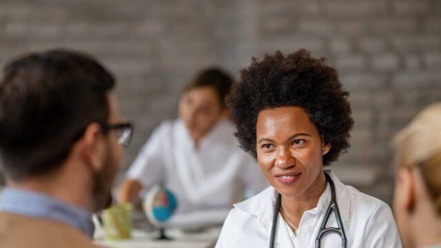 nurse-talking-to-two-men
