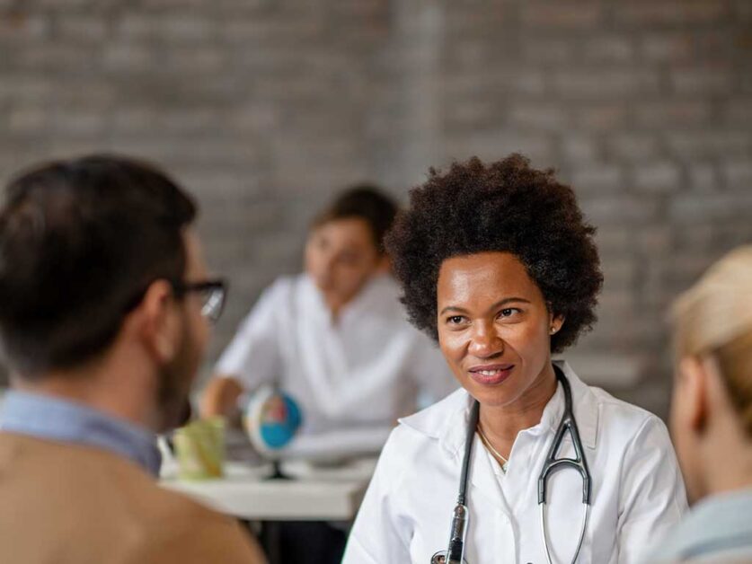 nurse-talking-to-two-men